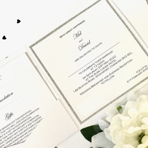 Crisp white and glitter pocketfold invitation with buckle