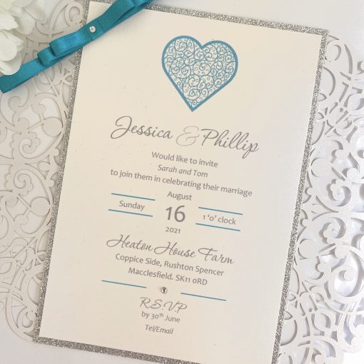 Crisp white laser cut invitation with teal dior bow detail