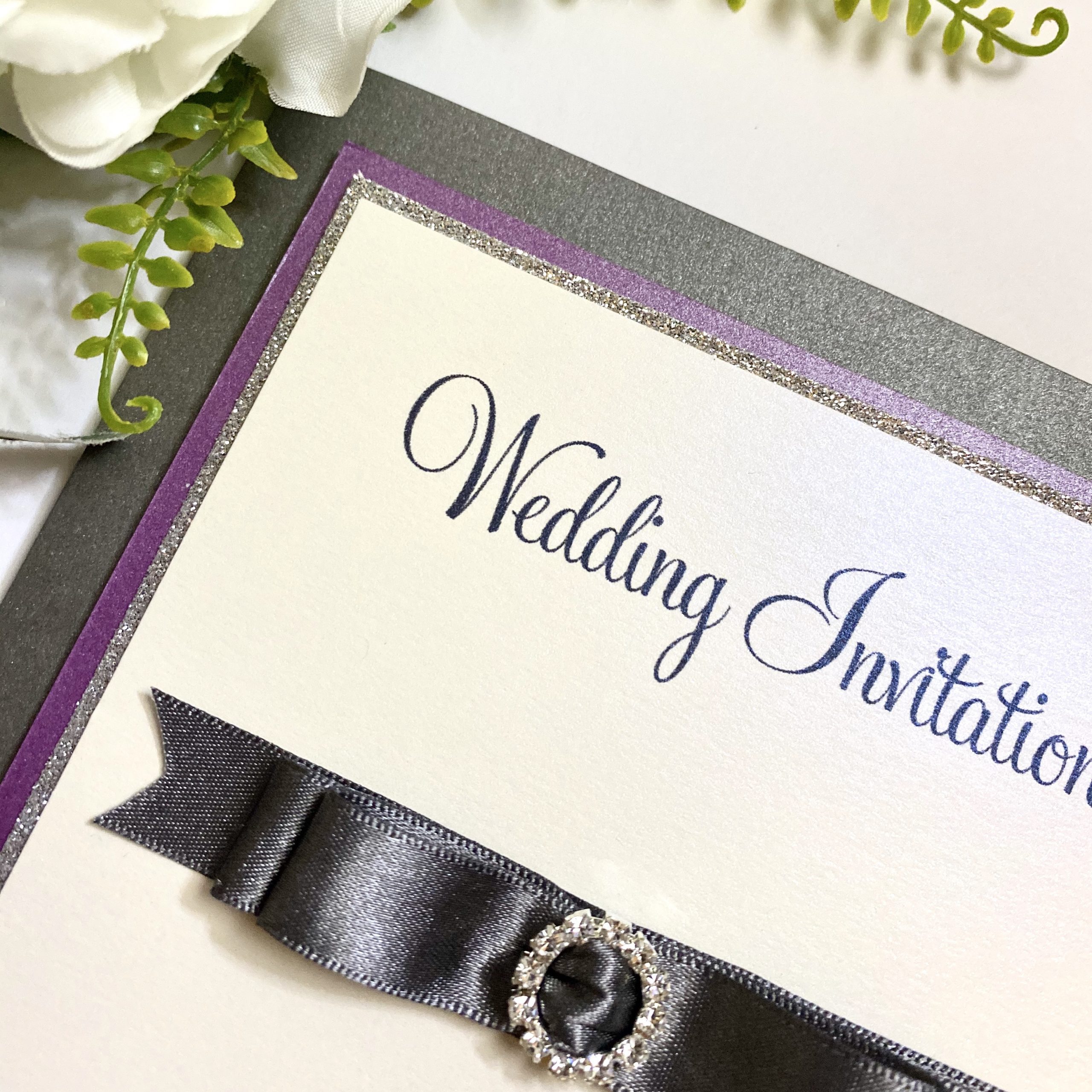 Classic folded invitation with gold dior bow.