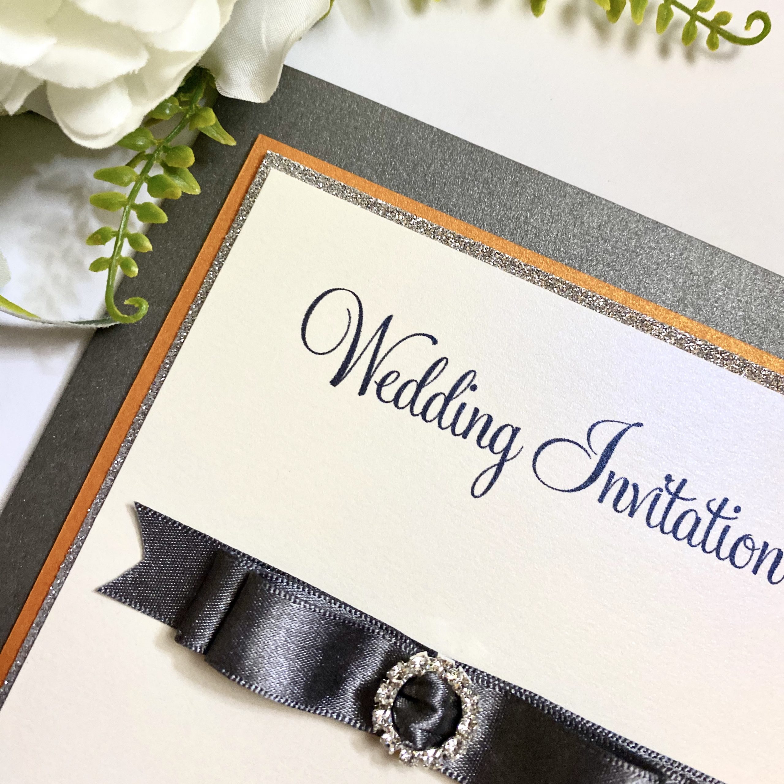 Grey pocketfold invitation with dior bow and buckle